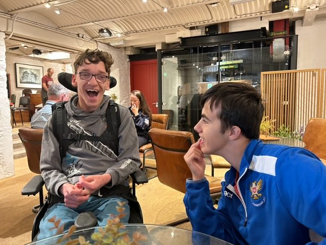 Two Boys sitting enjoying each others company